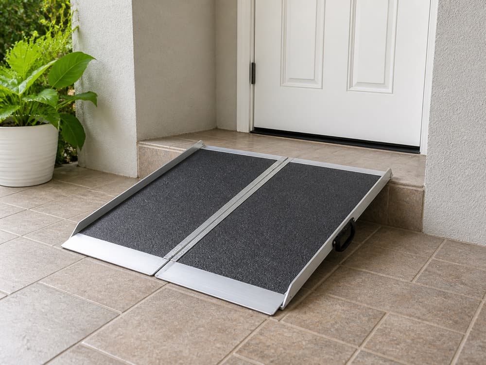 Portable folding suitcase ramp placed over a single low residential step